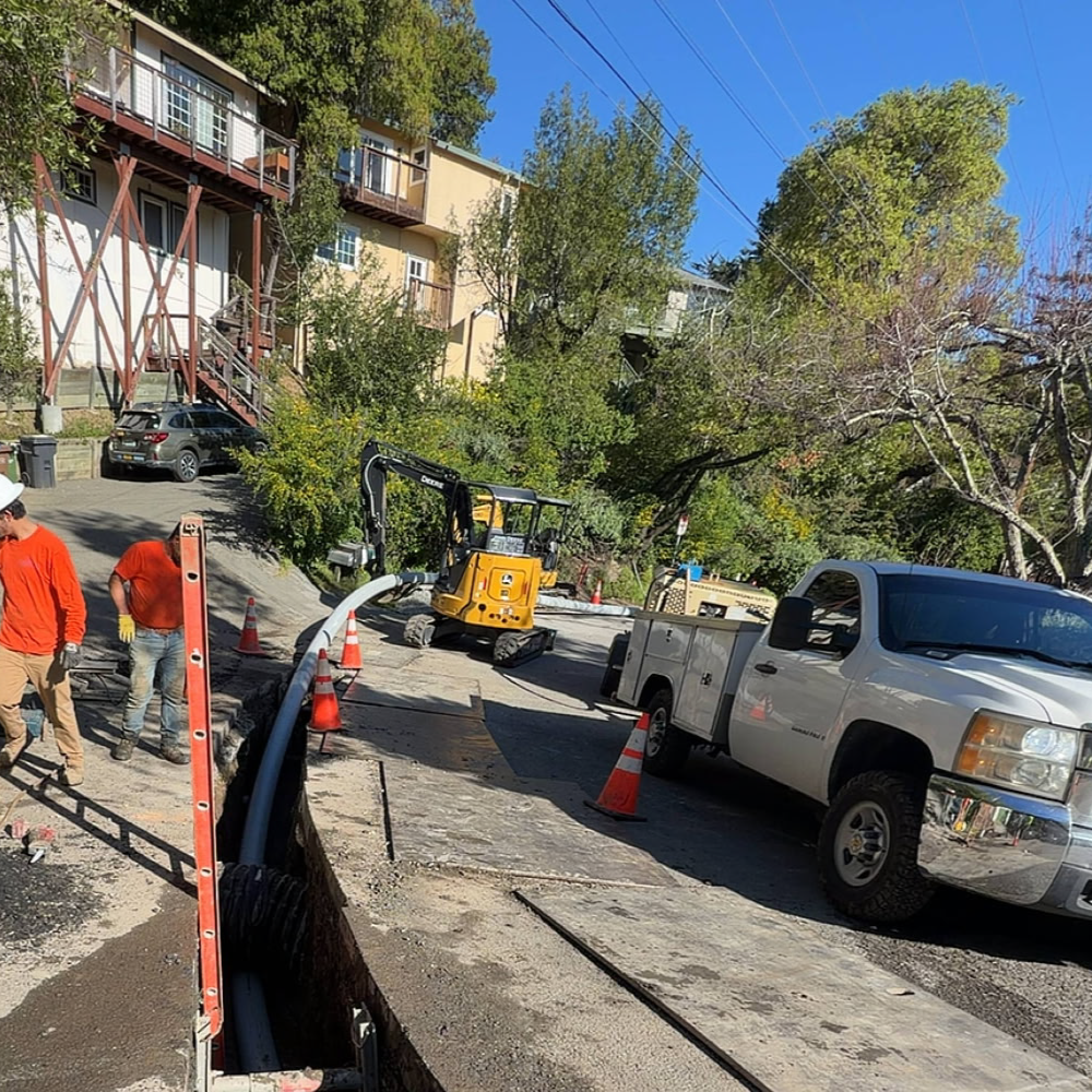 Bayside Trenchless crew completing a sewer main replacement project in a hillside residential neighborhood.